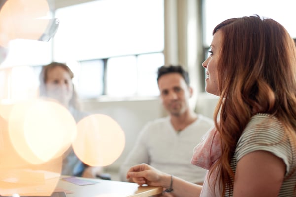 Unposed group of creative business people in an open concept office brainstorming their next project.-3